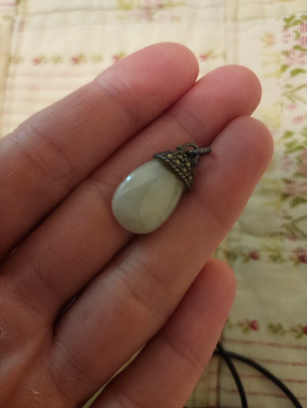 Green jade pendant with silver accents